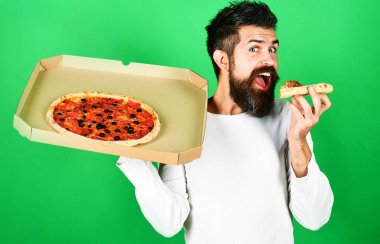 Hungry man eating slice tasty pizza. Food delivery home. Man with beard enjoying delicious pizza