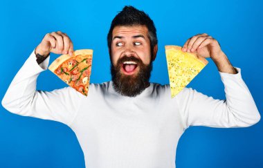 Handsome bearded man with slice of pizza. Hungry guy with delicious Italian pizza