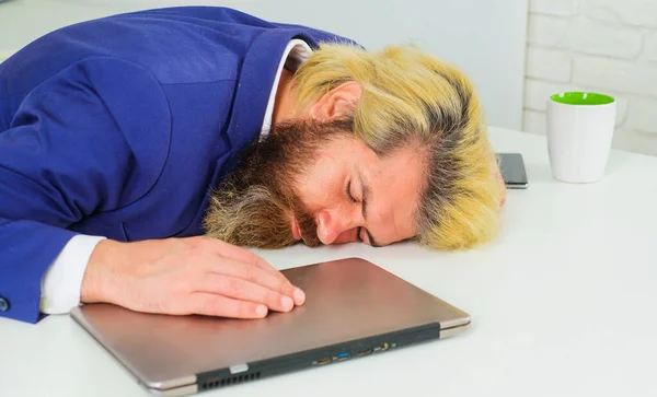 Tired businessman sleep on work desk. Office employee sleeping at workplace. Burnout and overwork