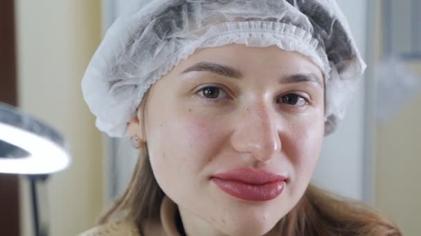 Trvalý make-up na rty. Detailní záběr tvář mladé ženy po permanentním make-upu.Obrovské oteklé rty — Stock video