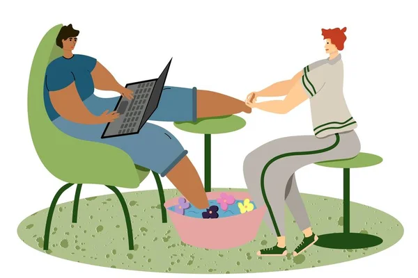 A man working at a computer is getting a pedicure in the salon. Salon employee gives foot massage to client.