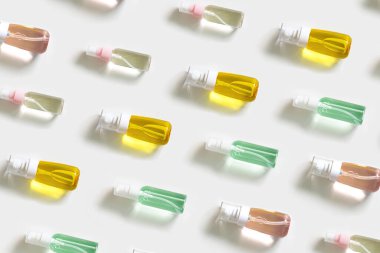 Beauty products mock up. Pattern from small bottle with transparent gel. Skincare, body treatment concept.