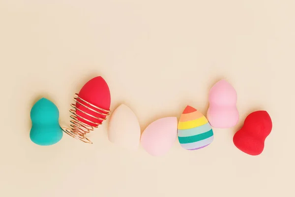 Color cosmetic beauty blender sponges on beige background Professional sponges different shape — Stockfoto