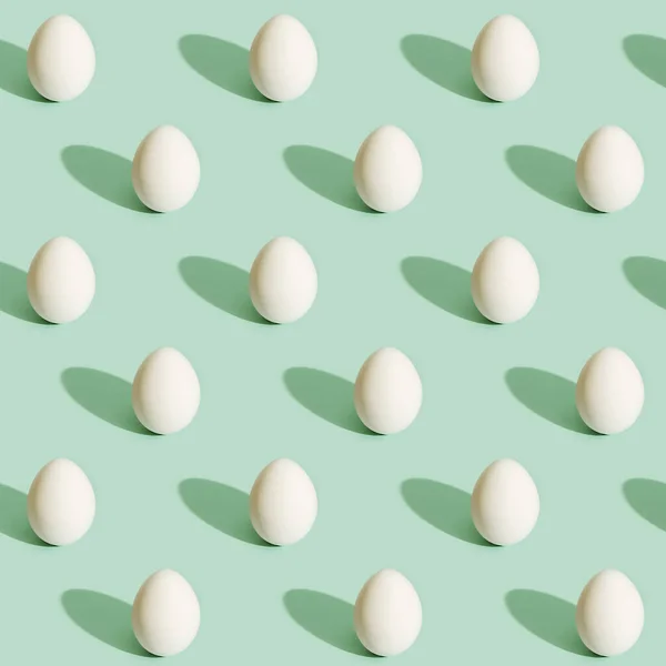 Seamless pattern from white eggs on light green paper. Food concept. Easter print. — Stock Photo, Image