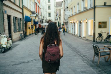 Şehirde sırt çantası taşıyan genç bir turist.