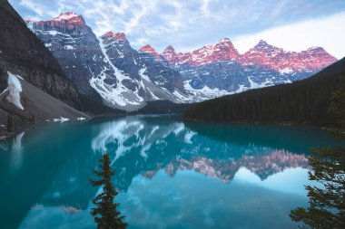 Scenic sunset or sunrise view of Moraine Lake landscape, a popular tourist destination in Banff National Park, Alberta, Canada in the Rocky Mountains.