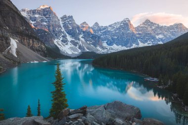 Scenic sunset or sunrise view of Moraine Lake landscape, a popular tourist destination in Banff National Park, Alberta, Canada in the Rocky Mountains.