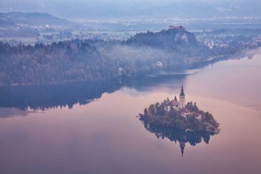 Amazing sunrise over popular tourist destination  Bled lake. Dramatic view of Pilgrimage Church of the Assumption of Maria. Location: Bled, Upper Carniolan region, Slovenia, Europe