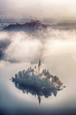 Amazing sunrise over popular tourist destination  Bled lake. Dramatic view of Pilgrimage Church of the Assumption of Maria. Location: Bled, Upper Carniolan region, Slovenia, Europe