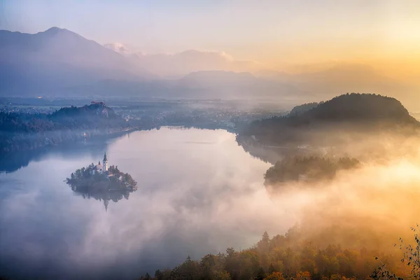 Amazing sunrise over popular tourist destination  Bled lake. Dramatic view of Pilgrimage Church of the Assumption of Maria. Location: Bled, Upper Carniolan region, Slovenia, Europe