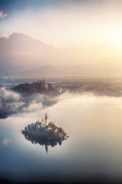 Fabulous sunrise over popular tourist destination  Bled lake. Dramatic view of Pilgrimage Church of the Assumption of Maria. Location: Bled, Upper Carniolan region, Slovenia, Europe