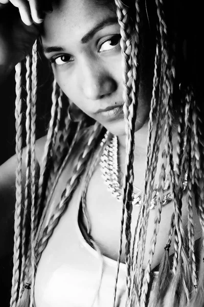 Siyah arka planda örgüler takan kızgın kadın.