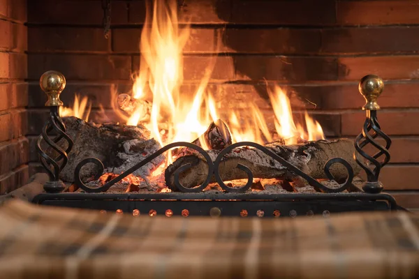 Winter blanket in front of a fireplace with a comfortable and cozy fire.