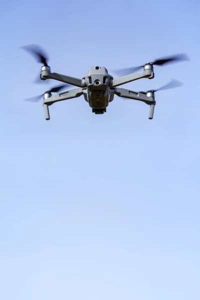 Mavi gökyüzünde uçan insansız hava aracı. Fotoğrafta bir sürü kopya alanı var..