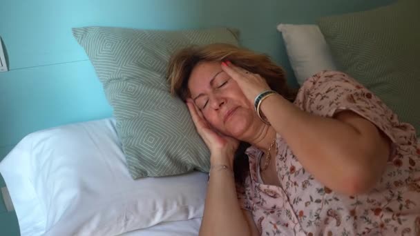 Olgun Bir Kadın Şiddetli Bir Baş Ağrısı Ile Odasında Yatakta — Stok video