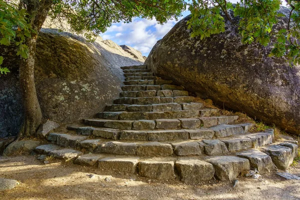 Stairs between the rocks to access the viewpoint of El Escorial in Madrid