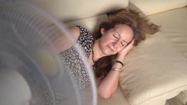 Woman Lying Sofa Giving Fresh Air Fan Because High Temperatures — Vídeo de stock