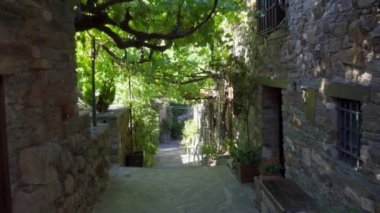 Narrow street of medieval old town with flash of light between buildings. Patones de Arriba Madrid