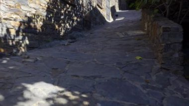 Small alley in stone mountain village with stray cat wandering the streets