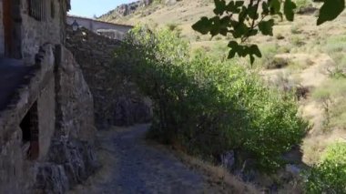 Beautiful old houses covered with ivy in medieval village. Patones de Arriba Madrid