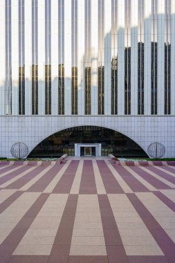 Madrid, Spain - July 30, 2022: Modern skyscraper of the city of Madrid, called Torre Picasso with geometric lines on its facade and on the ground