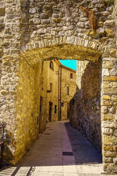 Stone arch in an alley of the medieval town of Besalu in the province of Gerona, Catalonia