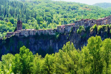 view of the rock that supports the medieval village of Castellfollit de la Roca in Catalonia, Spain at dawn