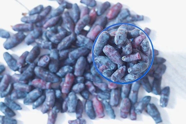 Blue Fresh Honeysuckle Berries Scattered White Table — Stock Photo, Image