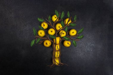 Siyah arka planda sarı elma yaprakları ve gövdesi elma ağacı şeklinde serilmiştir..
