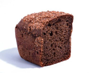 Half a loaf of rye bread close-up on a white background. A textured piece of dark bread with a sprinkle of bran. Healthy proper nutrition.