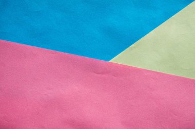 Çok renkli kağıtların soyut arkaplanı. Tasarım için desenli arka plan. Pembe, mavi ve sarı kağıtlar..