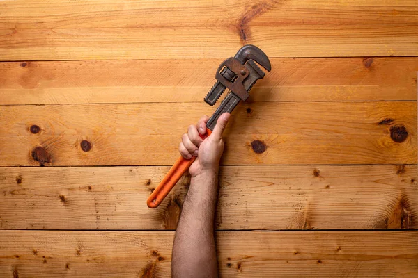 Hand Grabbing Pipe Wrenches Light Wooden Background Labor Day — Stock Photo, Image