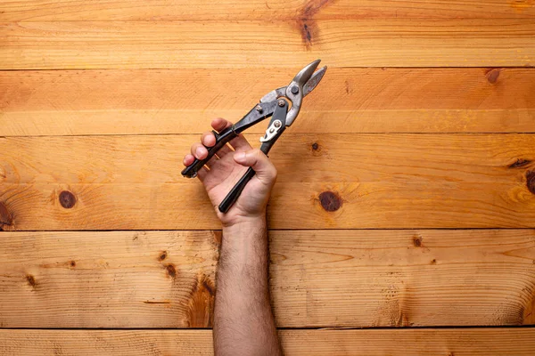 Hand Grabbing Aviation Scissors Light Wood Background Labor Day — Stock Photo, Image