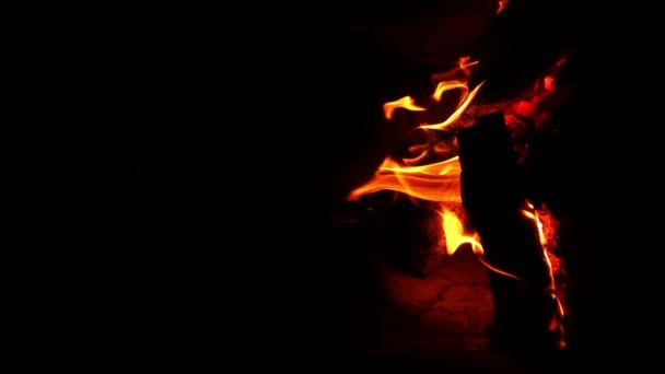 Vertical footage of burning fireplace in the darkness with vibrant tongues of flames — Stock Video
