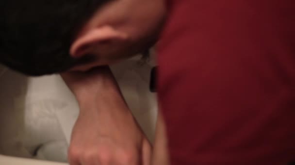 Macro footage filmed from above of vomiting man leaning on the toilet — Stock Video