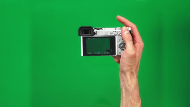 Set of 4 gestures of male hands holding silver photo camera and pushing button on green screen background — Stock Video