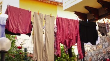 Elbiseler dışarıda temizlendikten ve rüzgarda titredikten sonra sıraya dizilir.