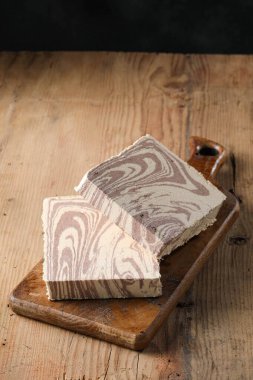 Cocoa halva, sliced cocoa halva on the cutting board, text space