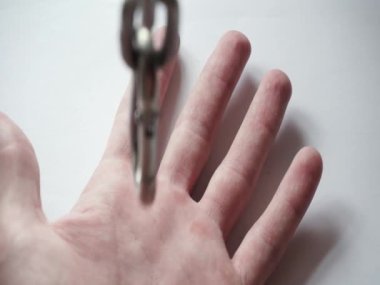 Steel chain in the hands of a man