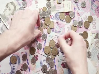 Adam Ukrayna kağıt banknotlarında farklı değerlerde Ukrayna paraları topluyor.