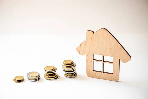 Coin money and house model on wooden background , Finance and banking concept.