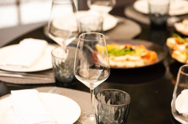 table setting with white wine and glasses, close up