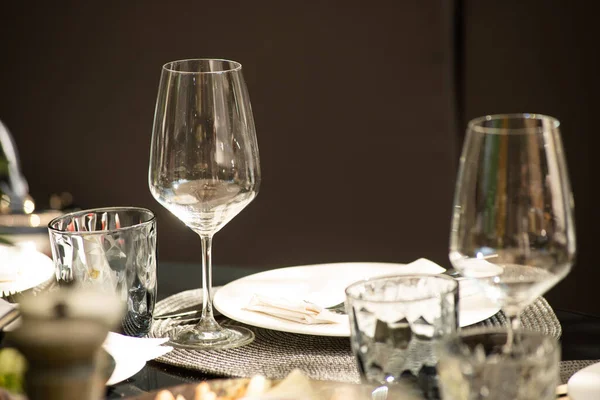 table setting with white wine and cutlery on the background of the restaurant