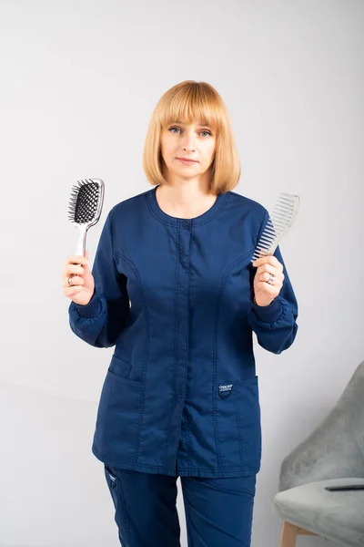 young woman with hair dryer on white background