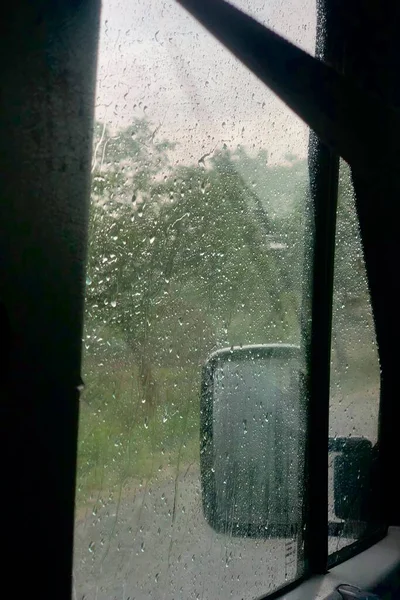 a shot of a car window with rain drops