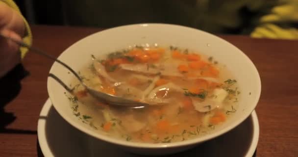 Homemade chicken soup with noodles and vegetables in white bowl. Healthy warm comfortable food. — Stock Video