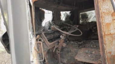 Cabin from the inside of a burnt and destroyed Russian armored military truck for transporting soldiers