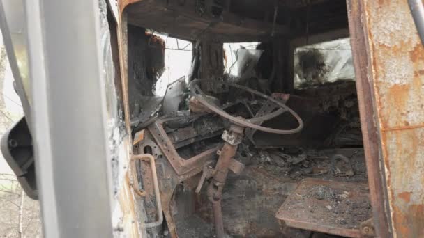 Cabin from the inside of a burnt and destroyed Russian armored military truck for transporting soldiers — Stock video