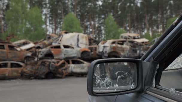 A lot of shot and destroyed civilian cars at the car cemetery in Irpin, Ukraine — 图库视频影像