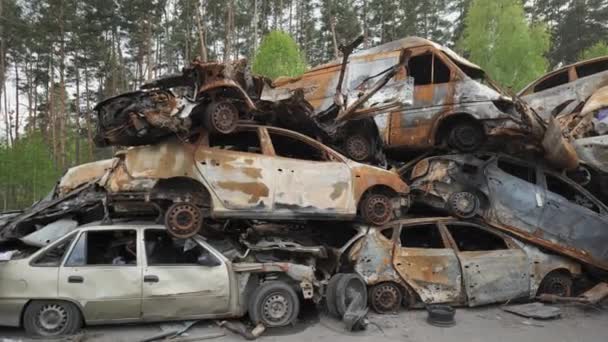 A lot of shot and destroyed civilian cars at the car cemetery in Irpin, Ukraine — Stockvideo